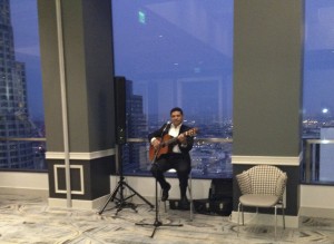 The guitarist, against the backdrop of the downtown skyscape.  Photo by Karen Salkin.