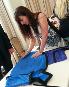 Media Personality Karen Salkin signing the Rein Coat for charity. Photo by Alice Farinas.