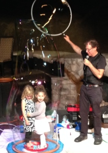 The Amazing Bubble Man entertaining two adorable young girls.  Photo by Karen salkin.