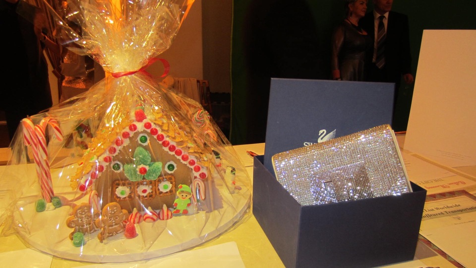 Just two of the gorgeous silent auction items--a gingerbread house, and a Swarovski crystal clutch! Photo by Alice Farinas.