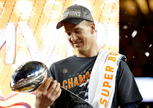 Champion Peyton Manning, admiring the Vince Lombardi Trophy.