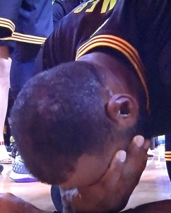 LeBron James, on the floor, overcome with emotion at finally accomplishing what he promised his beloved city he'd do. Photo by Karen Salkin.