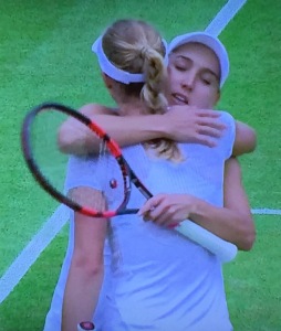 Elena Vesnina (facing us) embracing her doubles partner, Ekaterina Makarova, after she had beaten her in the singles.  Nice girls.  Photo by Karen Salkin.