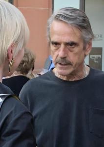 Jeremy Irons at the opening night after-party, chatting intensely with the best-dressed woman there. Photo by Mr. X.