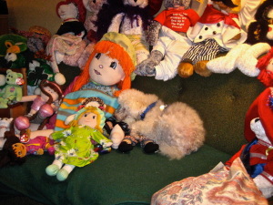 Clarence lying amidst just a few of Maybelle's stuffed pals! Photo by Mr. X.