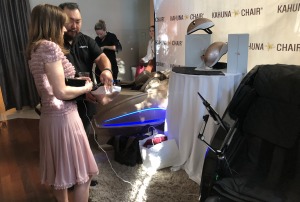 Green Book's Linda Cardellini learning about the massage chairs. Photo by Karen Salkin.