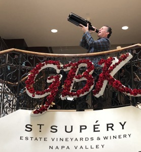 Gavin Keilly, CEO of GBK Productions, humorously showcasing a giant bottle of St. Supéry wine. Photo by Karen Salkin.