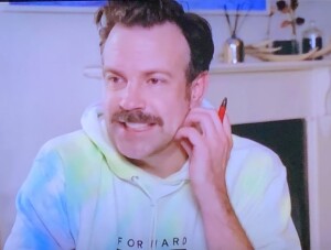 Jason Sudekis.  Besides the dirty hair and way-too-casual-for-an-awards-show hoodie, the red pen indicates that he was working during the announcement of his category, which is just rude.  Photo by Karen Salkin, off the TV screen.