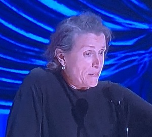 Frances McDormand., looking like she's waiting for her hair to be dyed and styled at the salon. Photo by Karen Salkin, (off the TV screen.)  