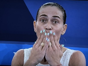Oksana Chusovitina blowing a faewill kiss to her many Olympics.  And you know I adore her nails, which matched her outfit, as well! Photo by Karen Salkin, off the TV.