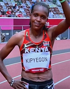 Faith Kipyegon's stomach, after having a baby.  But it didn't stop her from winning back-to-back Olympic Gold Medals! Photo by Karen Salkin, off the TV.