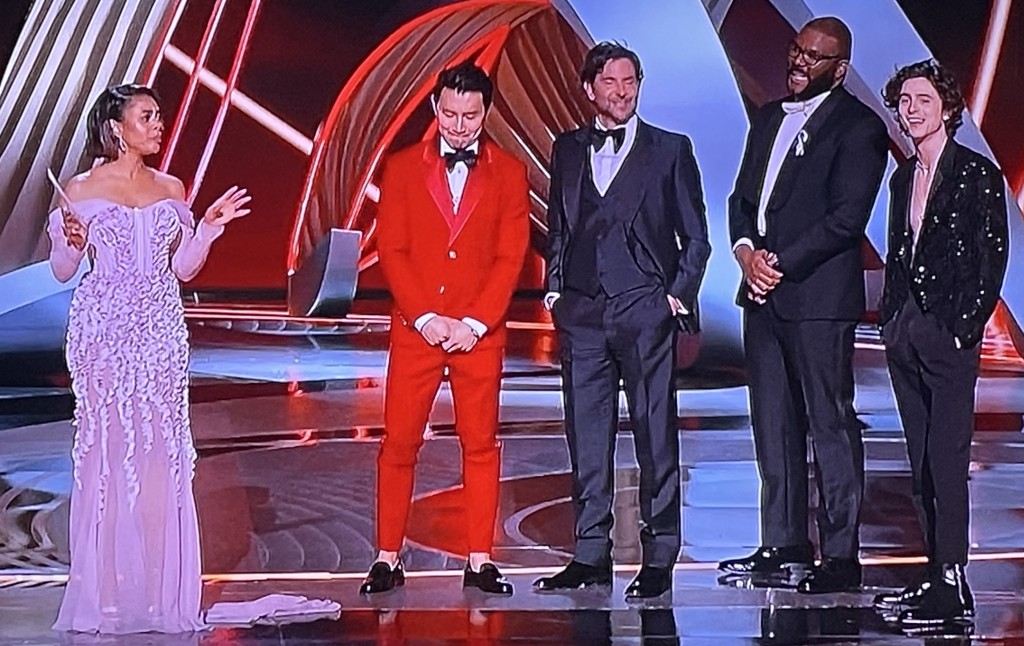 The creepy male-abusing bit by Regina Hall, (whoever she is.) She was joined on stage by otherwise-classy actors: (L-R) Simu Liu, Bradley Cooper, Tyler Perry, and Timothee Chalamet.  Photo by Karen Salkin.