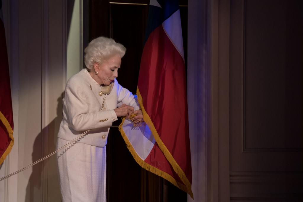Holland Taylor as Ann Richards, fixing the flag in her office, which is a hilarious bit!  Photo by Jenny Graham.