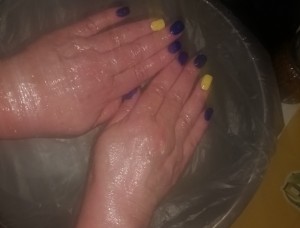 Karen Salkin's hands being exfoliated by Buie right on-site!  (Notice her Ukraine-colored nails.) Photo by Marc Winer. 