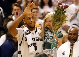 Adreian Payne sharing his Senior Night with little Lacey Holsworth.