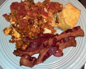 A colorful plate of Mexican casserole, cornbread, and tons of bacon. Photo by Karen Salkin, as is the big one at the top of this page, (which she snapped after most of the food was gone, because she had to eat and socialize first!)