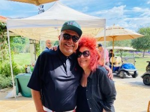 Doris Bergman with George Lopez at one of his golf classics, at which Doris gifted the celebs. 