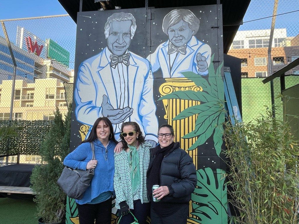 (L-R) Karen Salkin, Lynn Tejada, and Laura Saul celebrating in front of that beautiful mural of the incredible Ricardo Montalban and Herve Villechaize on Fantasy Island. Photo by a kind stranger.