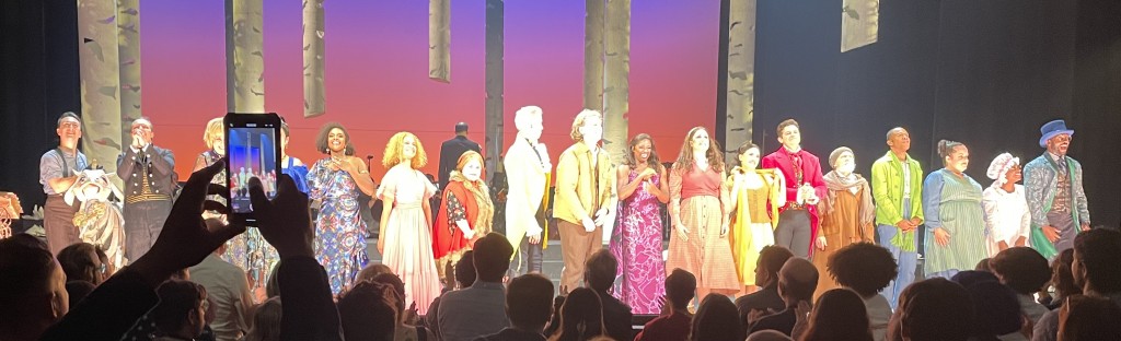 The Opening Night curtain call. The cow puppet I loved is at the far left. (Sorry about the creep who had to video tape the whole thing.) I have no pro pix of the whole cast, so this is the best I can do for you to see them all. Photo by Karen Salkin.