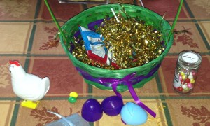 The start of an Easter basket for Mr. X. (The little chicken lays those e-words.) Photo by Karen Salkin.