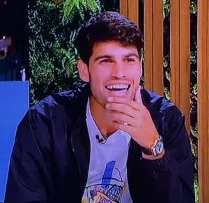 Adorable Carlos Alcaraz, watching a clip of something he did on court. Photo by Karen Salkin.