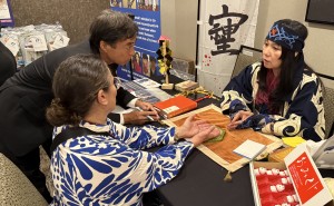 Neo Shaman Kozu giving a guest a "soul reading" through her interpreter. Photo by Karen Salkin.