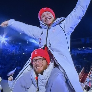 Ioulia Chtchetinina riding into the Closing Ceremony on the shoulders of her partner, Michał Woźniak, still smiling. Photo by Karen Salkin.