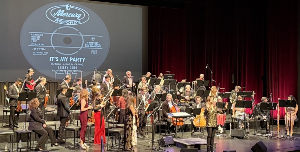 Rachel Worby in the center, Vanessa Bryan sitting on the front far left, Michael Abraham on the red guitar in the back left, Drew Forde on the second row far left, (right above Vanessa,) and Marisa Kuney in the red pants near the middle in front. Whew! Photo by Karen Salkin. 