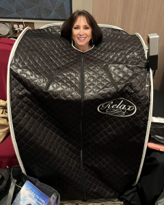 Karen Salkin's head sticking out of the perosnal sauna. And no--she did not cut her luxurious locks--she just put her hair behind her on top of the sauna! Photo by Chris D'Angelo.